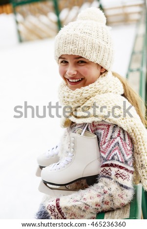 Winter sport, girl with a pair of ice skates
