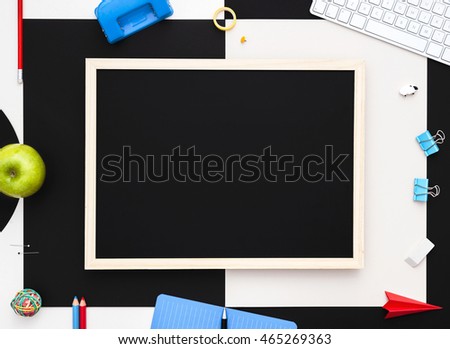 Back to school background with blank chalkboard. Variety of school supplies well organized with blank blackboard. Back to school concept. View from above. Copy space