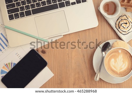 Office desk table with computer, supplies and coffee cup. Top view with copy space