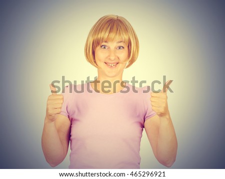 Beautiful happy young woman showing Ok, thumbs up sign isolated on background. Positive human emotions   