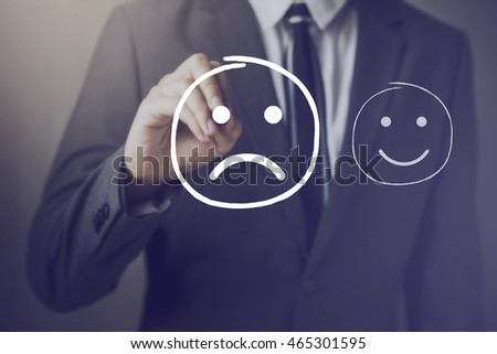 Customer choosing to write unhappy face on virtual screen over happy face Royalty-Free Stock Photo #465301595
