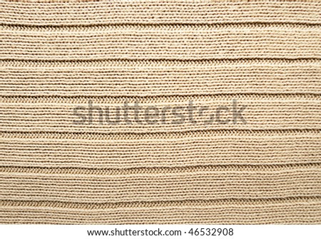 Close-up of beige ribbed knitted fabric