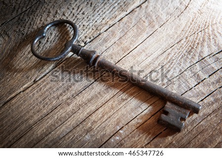 Old key on a wooden background. Shallow focus.