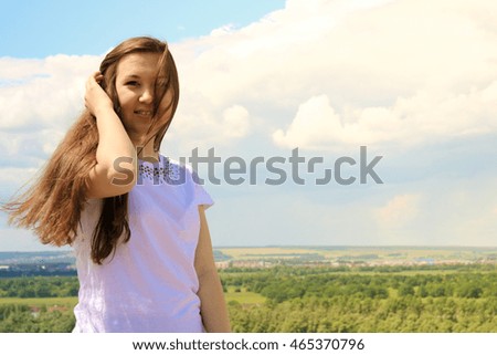 Young successful female Model on blue sky background