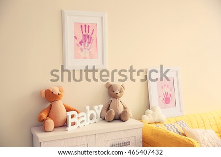 Frames with family hand prints in room interior