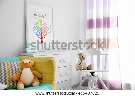 Frame with family hand prints in room interior