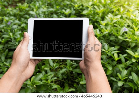 Man using tablet in a garden