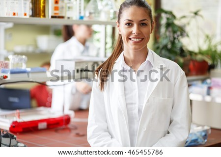 Young female scientist standing in her lab. Royalty-Free Stock Photo #465455786