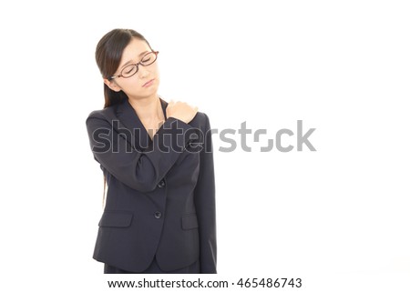 Business woman who has a shoulder pain.
