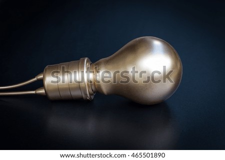 Gold Light Bulb on blackboard background with copy space.
