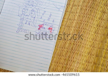 thai mixed race young little kid girl drawing family picture in paper with pen on mat for hobby, countryside lifestyle