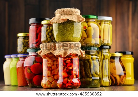 Jars with variety of pickled vegetables. Preserved food Royalty-Free Stock Photo #465530852