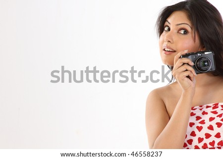 caucasian woman holding a camera, white background