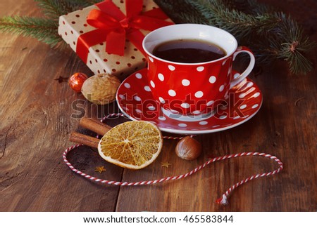 Christmas cup of tea with gift, orange, nuts and Christmas decor