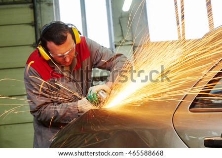 collision repairs service. mechanic grinding car body by grinder Royalty-Free Stock Photo #465588668