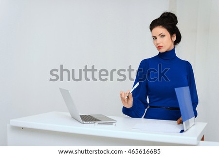 business woman working in the office blue dress