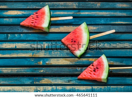 Delicious fresh watermelon. Ice cream with watermelon. ice cream fruit. Delicious watermelon on a blue wooden background. Closeup. Place for text.