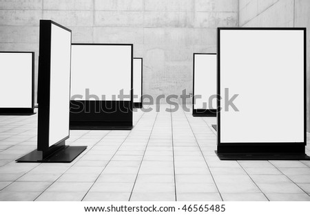 Blank frames shown in concrete room.