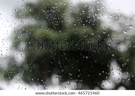 rain drops on the window with bokeh street view . vintage concept for background
