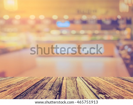 image of selective focus on surface of wood table and blur people at japanese  buffet catering room for background usage .