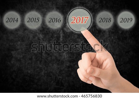 Hand of a young girl points to a figures 2017.