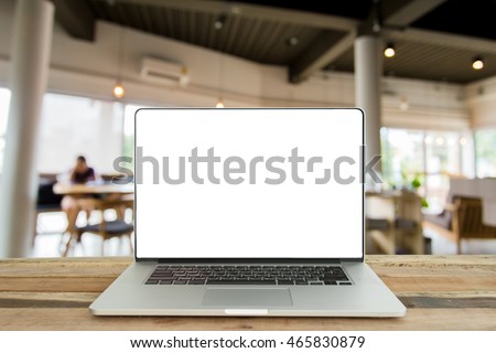 Open laptop with isolated white screen on old wooden desk