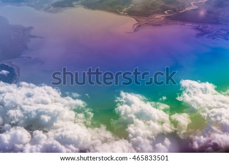 Airplane flying, cumulus clouds over Black sea and Caucasus mountains. View of sky from aircraft, long distance travel by airtransport. Russian airlines, Krasnodar Krai