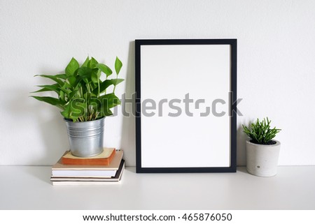 mock up photo frame with book and plant pot. home decor