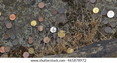 Old money and many coins on the Porta Nigra in Trier