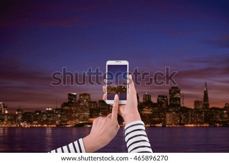 travel concept - tourist taking photo of panorama skyline at night on mobile gadget