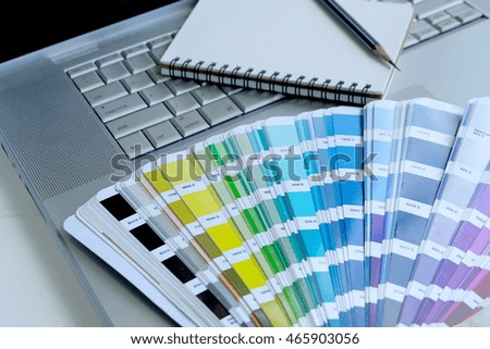 Color palette guide on white background,Focus exclusively on ,table working on laptop computer and book

