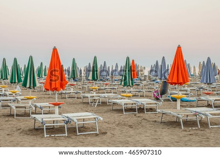 LIGNANO, ITALY: Beach with closed umbrellas and sunbeds in the evening.   
