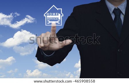 Businessman pressing hammer and wrench with house icon over blue sky with white clouds background, Home service concept