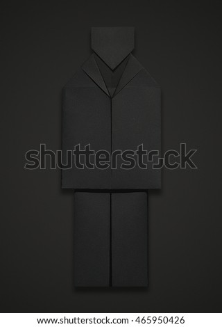Black origami man in a suit on a black background