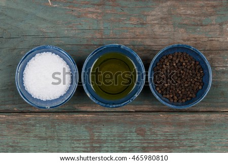 Salt, pepper and oil on a wooden table, stock picture