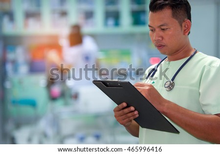 Doctor writing a medical prescription in hospital