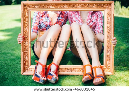 Group of friends at park having fun party. Rockabilly hen-party in park. Feet of girls in the picture frame