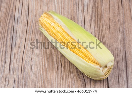 Corn on wooden background