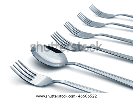 Spoon in a row of forks isolated on white