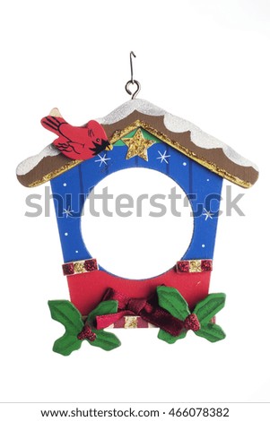 Christmas tree ornament. Framed bird house isolated over a white background.