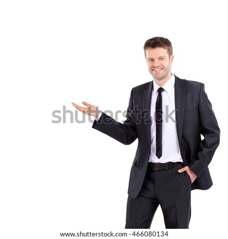 Smiling business man showing open hand palm with copy space for 