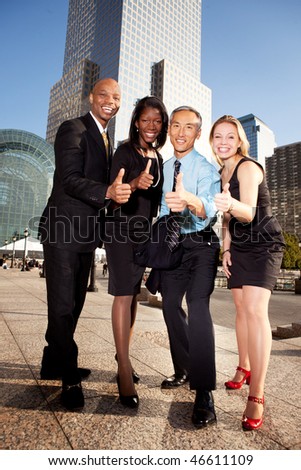 A group of business people giving a thumbs up sign