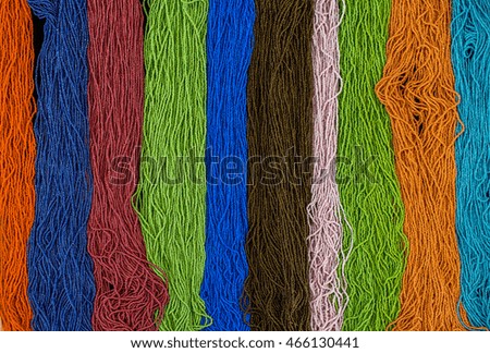 Background rainbow of colorful beaded necklaces and bracelets