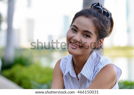 Portrait of happy Asian woman smiling outdoors