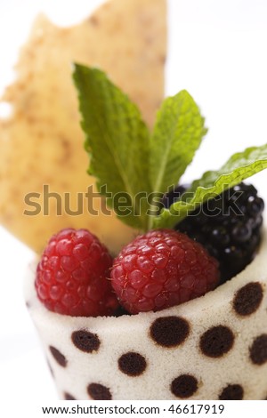 Close-up of a dessert fruit cup with mint leaves. Vertical shot.