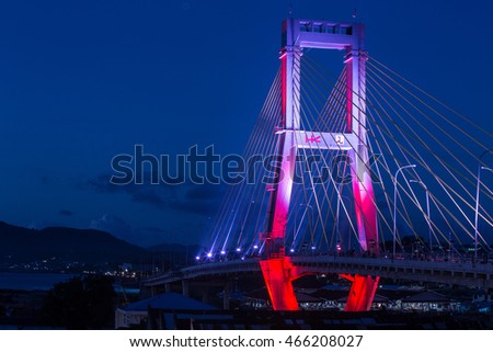 The Sukarno Bridge over the harbor in Manado by night, North Sulawesi, Indonesia Royalty-Free Stock Photo #466208027