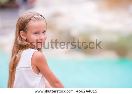Adorable little girl background Trevi Fountain, Rome, Italy. Happy toodler kid enjoy italian vacation holiday in Europe.