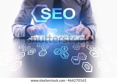 Businessman using tablet pc and selecting "SEO".