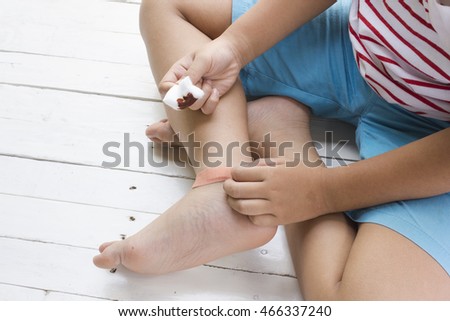 Child wound on leg and druging wounds on wooden white background,Top view and close up