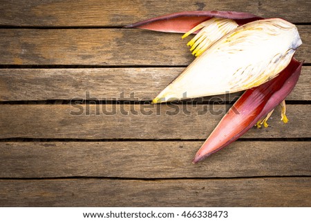 Banana blossom on wooden background.Raw food or background food.